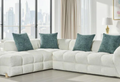 Modern white sectional sofa with teal pillows