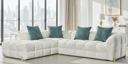 Modern white sectional sofa with teal pillows