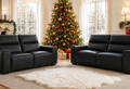 wo black leather electric recliner sofas facing each other in a cozy living room decorated for Christmas