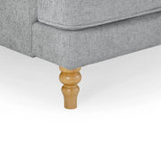 Gray upholstered chair with wooden leg