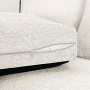 Close-up of a textured gray sofa with a zipper detail.