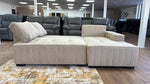 Beige sectional sofa in a furniture store setting